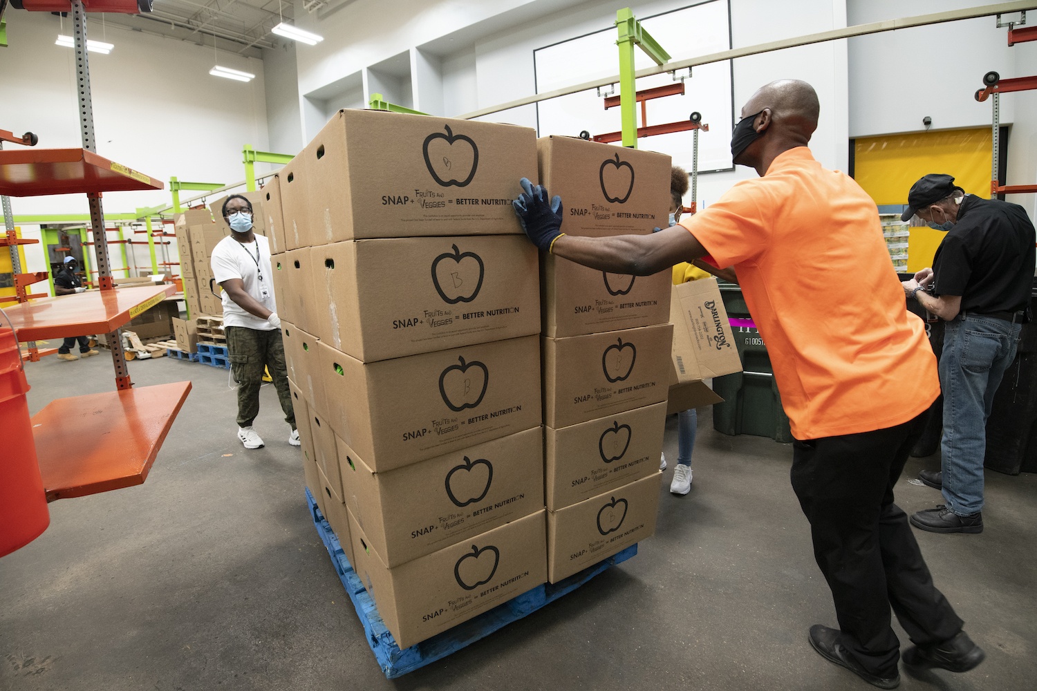 Houston Food Bank workers transporting SNAP fruit and veggie boxes, September 2020