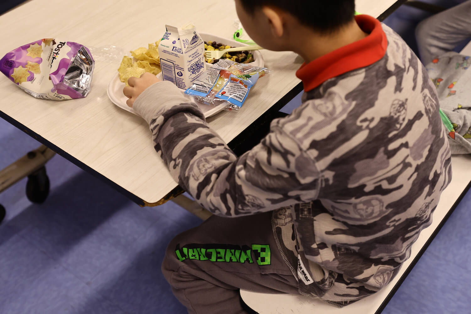 A student eats a vegan meal served for lunch (with milk as a drink) at Yung Wing School P.S. 124 on February 04, 2022 in New York City.